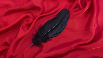 Black Feather On Red Silk Fabric, Elegant Still Life Composition, Smooth Texture, Luxurious Design Element, High-Contrast Colors, Holiday Decor Potential, Artistic Display, Close-Up View photo