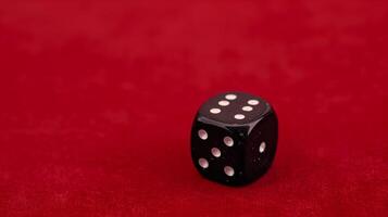 Close-Up of Black Dice on Red Background with White Dots, Minimalist Style, Gambling Concept, High Contrast, Game Night Vibes, Single Object Focused photo