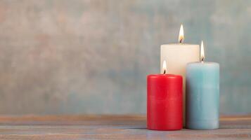 Three Colored Candles, Red, White, and Blue, Lit on Wooden Surface with Blurred Background, Celebrating Festive Occasions and Cozy Home Decor, Winter Warmth, Christmas New Year Calm and Serene Setting photo