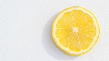 A slice of lemon on a white surface photo