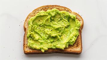 Single Slice of Toast with Creamy Mashed Avocado on Clean White Background for Healthy Breakfast or Snack Concept photo