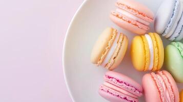 Overhead View of a White Plate with Colorful Macarons Against a Soft Pink Background Showing Assorted Flavors and Pastel Colors, Ideal for Dessert, Bakery, and Confectionery Themes, Spring Celebration photo