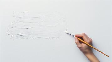 Hand Holding a Paintbrush Applying White Paint on Canvas - Close Up Artistic Creation Concept for Design Background and Creative Projects in Minimalist Style with Focus on Texture and Brushwork Detail photo