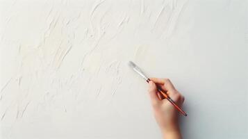 Close Up of Person Holding Paintbrush Painting Abstract Textured White Canvas Background Art Creativity Expression Minimalist Artistic Design photo