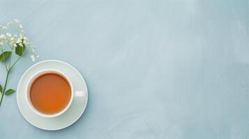 Top View of a Cup of Tea with Flowers on Light Blue Background, Minimalistic Clean Workspace, Refreshing Spring Morning, Simple and Elegant Design, Tranquil Moment, Perfect for Relaxation photo