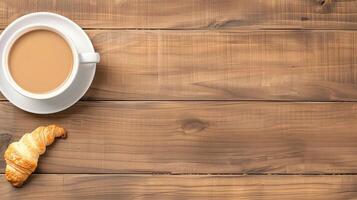 Overhead Shot of Coffee Cup and Croissant on Wooden Table Reflecting Rustic Morning Vibes with Vintage Charm Perfect for Breakfast Hamper Advertising or Cozy Lifestyle Presentations and Holiday Themes photo