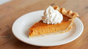 Delicious Pumpkin Pie Slice Topped with Whipped Cream on White Plate, Perfect for Thanksgiving and Fall Desserts photo