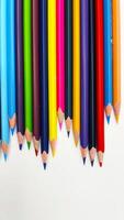 Colorful sharpened pencils are lined up on the table. photo