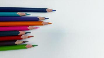 Colorful sharpened pencils are lined up on the table. photo