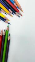 Colorful sharpened pencils are lined up on the table. photo