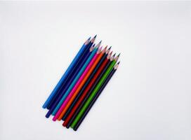 Colorful sharpened pencils are lined up on the table. photo