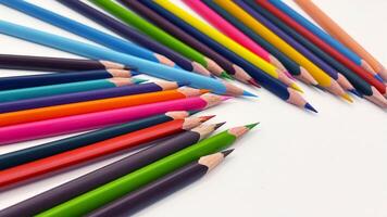 Colorful sharpened pencils are lined up on the table. photo