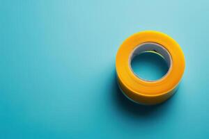 Yellow adhesive tape on a blue background during daylight photo