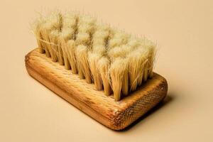 Wooden grooming brush with natural bristles on a neutral background photo