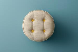 Round tufted stool on a light blue background with yellow buttons photo