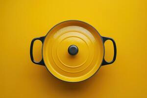 Bright yellow cooking pot on a vibrant yellow background photo