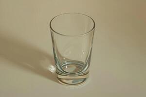 Empty glass on a smooth surface with soft lighting photo