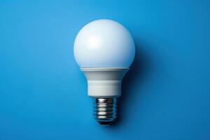 Bright LED light bulb against a blue background photo