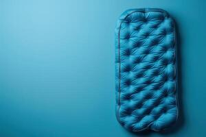 A vibrant blue camping mat displayed against a matching background photo