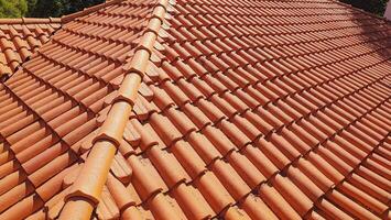 Clay tile roof. Banner with orange clay tile roof close-up on blue sky background with space for text, copy space. photo