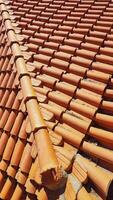 Clay tile roof. Banner with orange clay tile roof close-up on blue sky background with space for text, copy space. photo