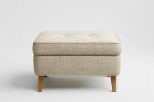 Soft beige tufted ottoman with wooden legs in a minimalist interior setting photo