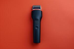 Hair clipper on a bright orange background with a sleek design for grooming photo