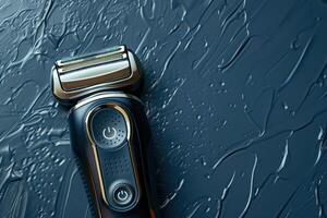 Electric razor resting on a wet, textured surface with a dark background photo