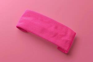 Bright pink headband on a pastel pink background photo