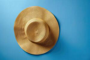 Stylish straw sun hat placed on a vibrant blue background photo