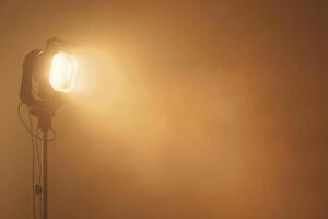 Spotlights illuminating a misty studio during a creative photoshoot session photo