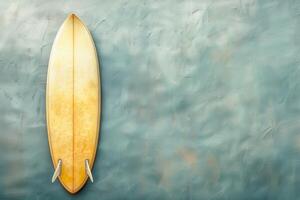 Vintage yellow surfboard against a textured blue wall in a coastal setting photo