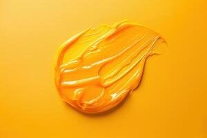 Bright yellow paint smear on vibrant orange background photo