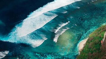 Aerial view of scenic coastline with ocean waves and current canal and Green bowl beach, drone view photo