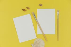 Blank paper mockup with brush and shells photo