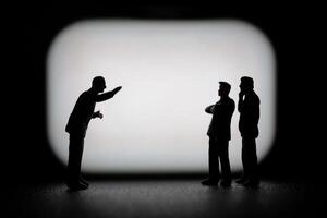 Miniature businessman in a professional agreement, with a blurred background to emphasize the interaction. photo