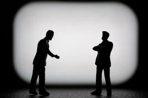 Miniature businessman in a professional agreement, with a blurred background to emphasize the interaction. photo