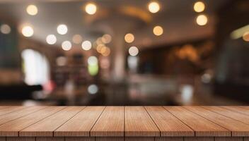 Empty wooden table top with lights bokeh on blur restaurant background photo