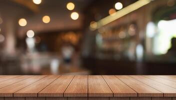Empty wooden table top with lights bokeh on blur restaurant background photo