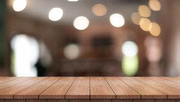 Empty wooden table top with lights bokeh on blur restaurant background photo