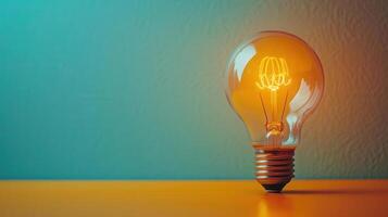 A glowing light bulb emits warm illumination against a vibrant backdrop, symbolizing creativity and innovation. photo