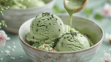 Delicious mint ice cream served in a bowl with a drizzle of matcha sauce and garnished with chocolate sprinkles. photo