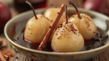 Delicious poached pears served in rich syrup with a hint of cinnamon, perfect for desserts and festive occasions. photo