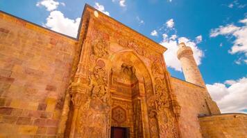 Main gate and minaret of Great mosque of Divrigi or Divrigi ulu camii time lapse with motion of the clouds. video