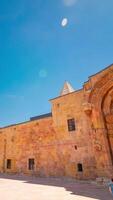 Divrigi Ulu Cami and Darussifa aka Great Mosque and hospital of divrigi time lapse vertical footage with motion of the people and panning motion from left to right. video