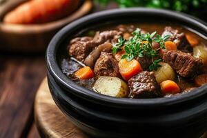 Delicious beef stew with vegetables in a rustic bowl and blurred background. photo