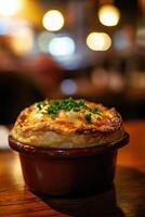 Delicious chicken pot pie with fluffy crust and herbs on wooden table in cozy setting. photo