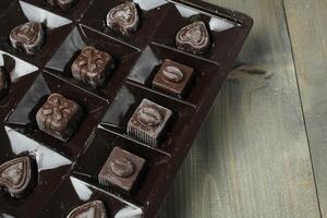 Chocolates in a box of correx on a rum background. Candy Storage Holiday Gift photo