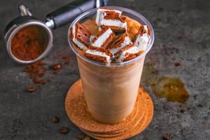 Iced Sandwich Coffee with Cookies and Cream and coffee beans in glass isolated on background side view of healthy and delicious beverage photo