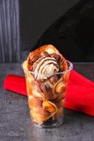 Chocolate Dipped Egg Waffle Cup with vanilla Ice Cream side view of ice dessert photo